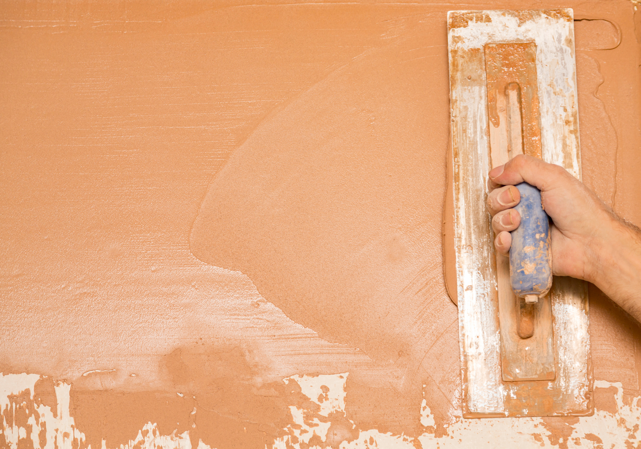 Plasterer plastering a wall