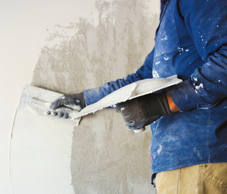 worker plastering tool plaster marble on interior plaster rough